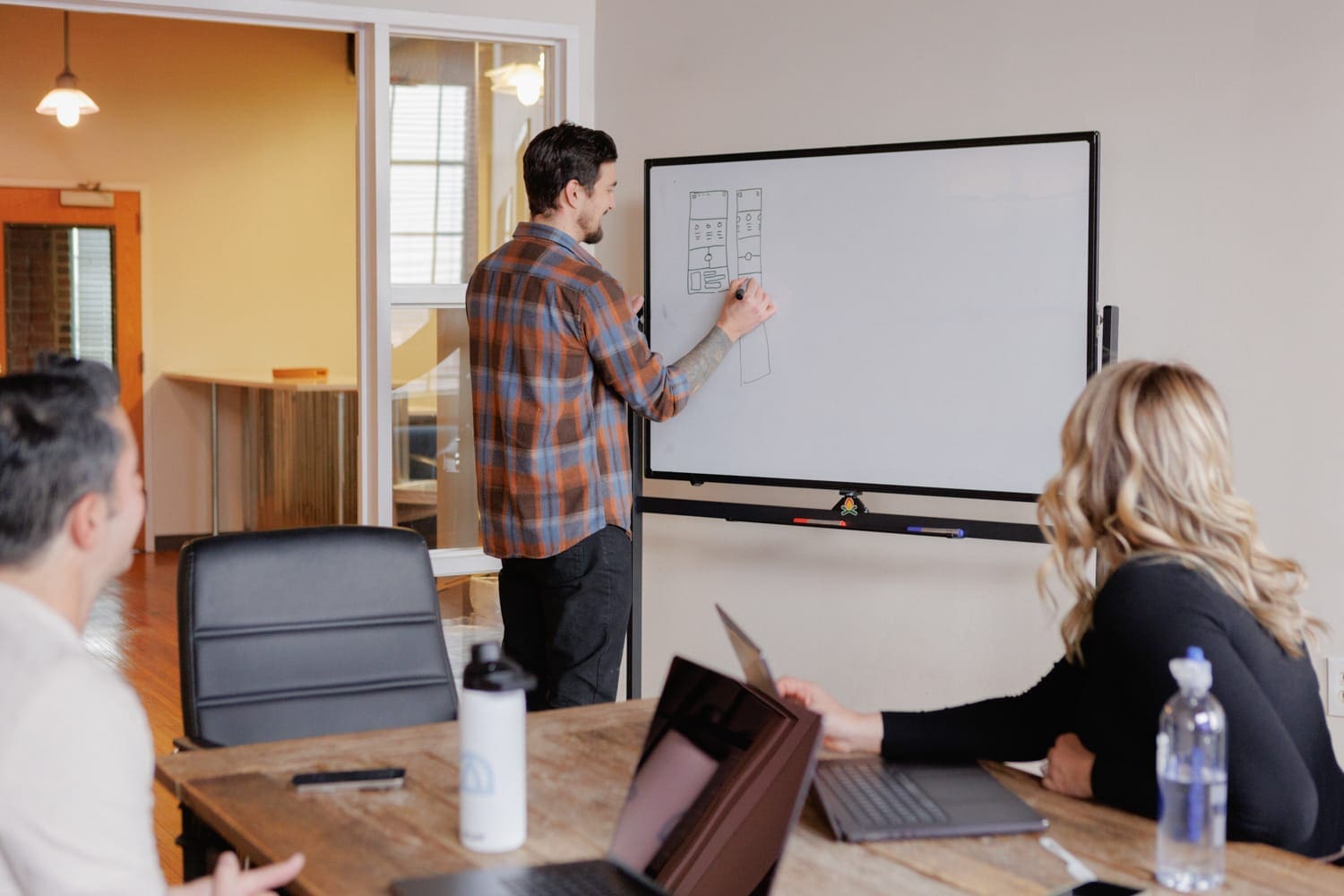 Cloud Connex team member giving a presentation at whiteboard