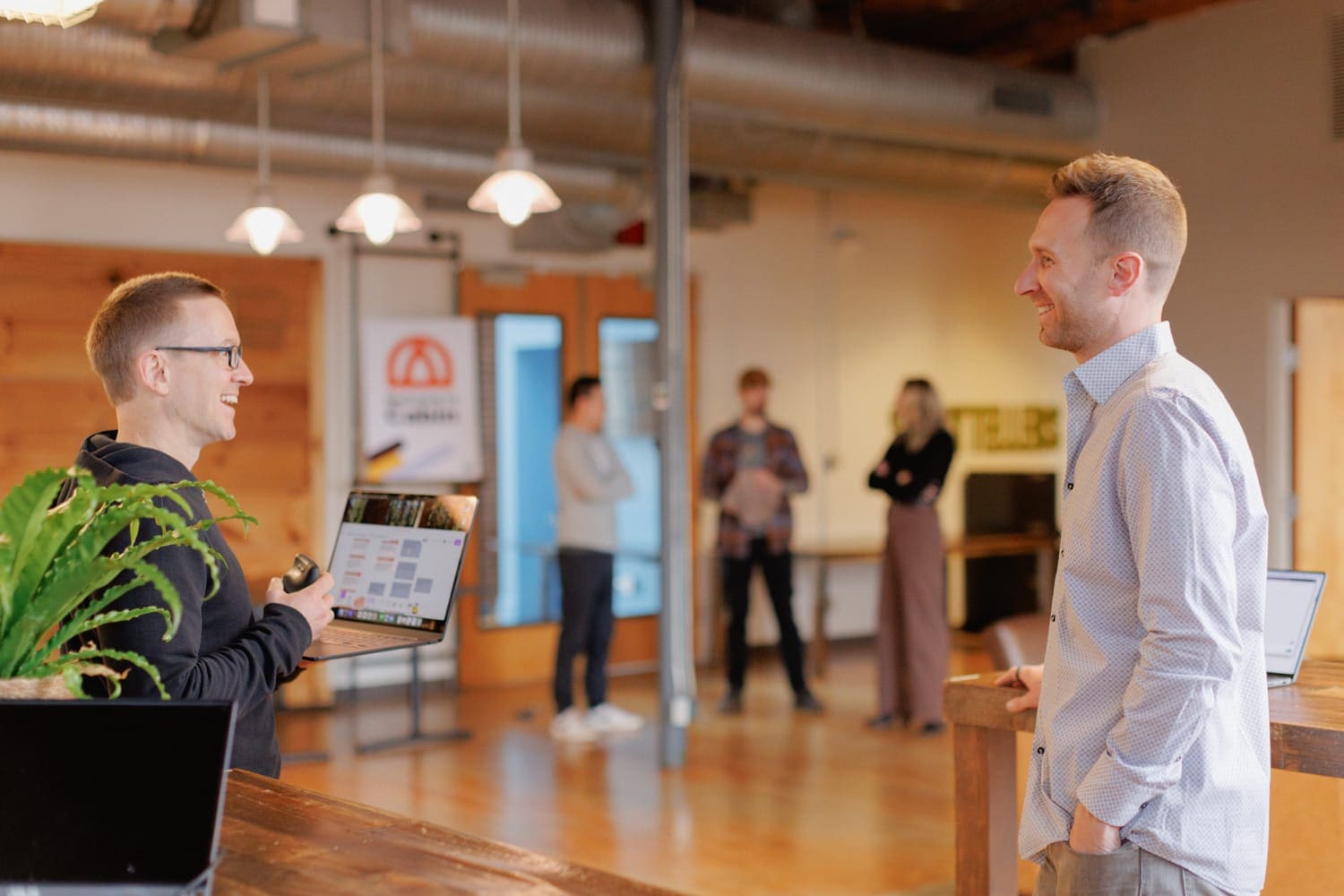 Smiling Cloud Connex team members enjoying a lighthearted conversation