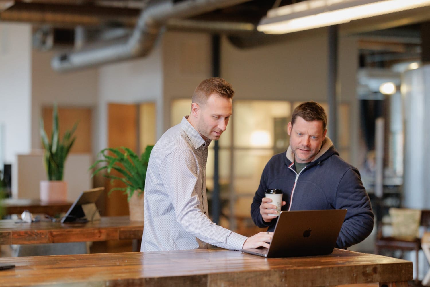 CloudConnex team members focused on projects together in a collaborative open office setting